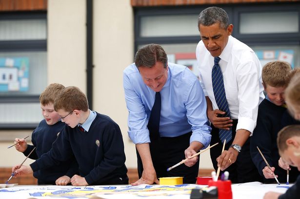 President-Barack-Obama-and-Prime-Minister-David-Cameron-help-out-as-students-work-on-a-school-project-1958826